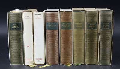 several books are lined up in a row on a black surface