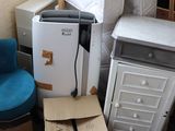 a lot of boxes and a refrigerator in a room