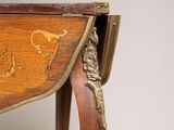 a wooden table with a carved design on the top of it