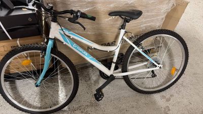 un vélo posé par terre devant un carton