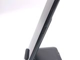 a cell phone on a stand on a white surface