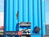 a blue container that is sitting in the middle of a parking lot