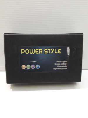 a black power style battery charger sitting on top of a white table