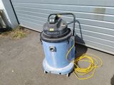 a blue and black wet dryer sitting on the ground