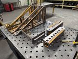 many pieces of metal on a table in a warehouse