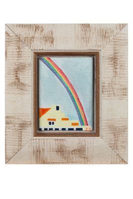 une image représentant une maison avec un arc-en-ciel dans le ciel