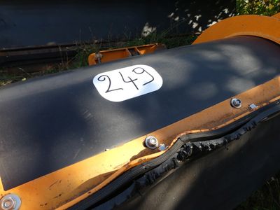 an image of a black and orange motorcycle with a number plate on it