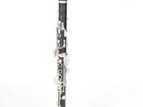 a black and silver clarinet that is on a white surface