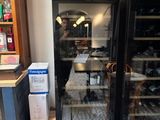 a man standing in front of a refrigerator in a kitchen