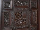 a wooden cabinet with carvings on it in a room