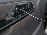 a close up of a car door handle with wires attached to it
