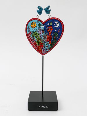a close up of a sculpture of a heart with birds on it