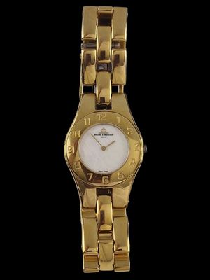 an image of a close up of a gold watch on a black background