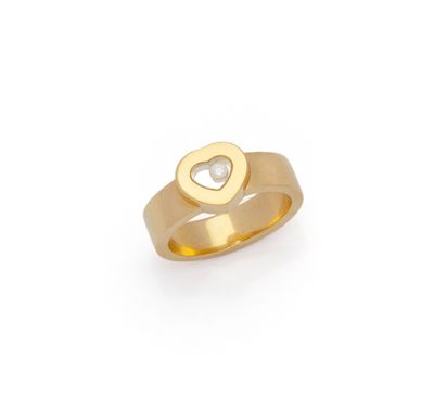 a close up of a gold ring with a heart on it