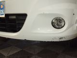 a close up of a white car with a license plate on it