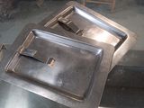 two trays of food sitting on a glass table