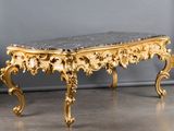 an image of a table with a marble top and gold decorations