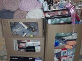 a cardboard cart with many items in it in a warehouse