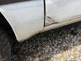 a close up of a truck ' s tire on a gravel road