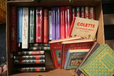 a box full of books sitting on top of a table
