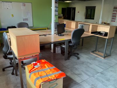 a room with a lot of desks and chairs in it