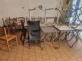 many chairs and tables in a room with a window