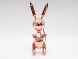 a close up of a metal rabbit figurine on a white background