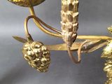 a gold candle holder with two candles on it