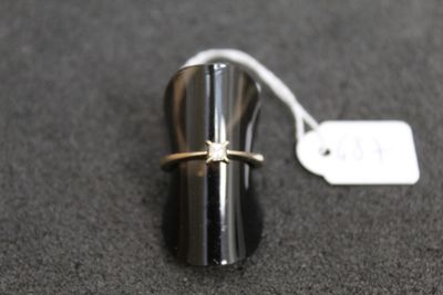 a ring on top of a metal object with a price tag on it