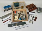 a wooden box filled with assorted items on a table