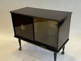 an image of a small black cabinet with a glass door