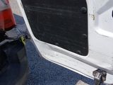 a close up of the door of a white truck