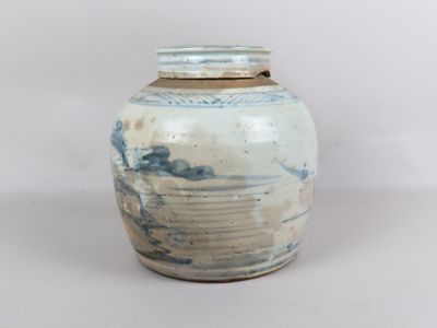 un vase bleu et blanc posé sur une surface blanche