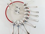 a lot of spoons arranged in a circle on a plate