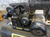 an air compressor sitting on top of a table in a room