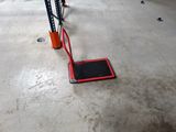 a red platform on the floor in a garage