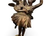 bronze statue of a couple of dancers on a pedestal