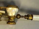 a pair of brass and glass lamps on a white background