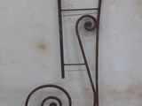 wrought iron letter h on the side of a building