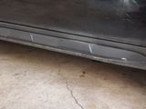a car that has been painted black and has a hole in the side of it