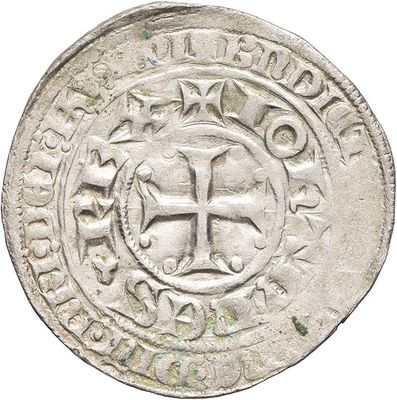 a close up of a silver coin with a cross on it