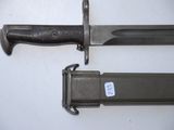 two knives that are laying next to each other on a table