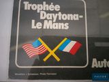 a sign that says tropie daytona - le - mans with two flags
