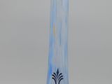 an antique blue and yellow glass vase sitting on top of a white table