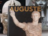 deux livres posés sur une table, à côté d'une statue d'homme et d'une statue de femme