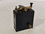 a small black box with brass fittings on top of it
