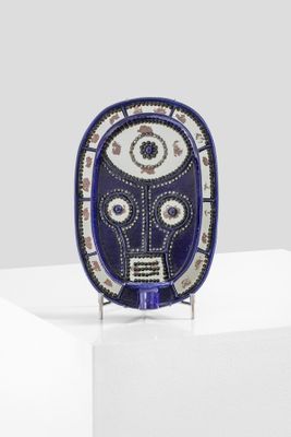 an image of a blue and white mask on a white pedestal