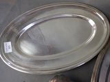 a silver plate on the table next to a pair of shoes