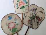 three chinese hand painted fan on a white surface