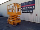 a picture of a yellow scissor parked in front of a building